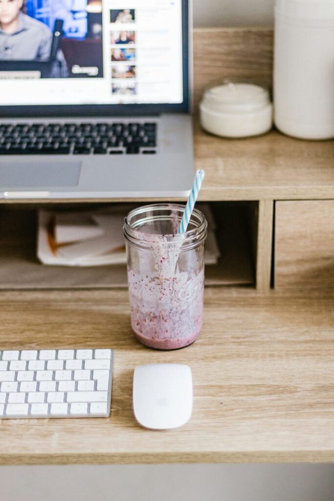 Productivity smoothie Playa del Carmen digital nomad blends at a bright open coworking desk with laptop